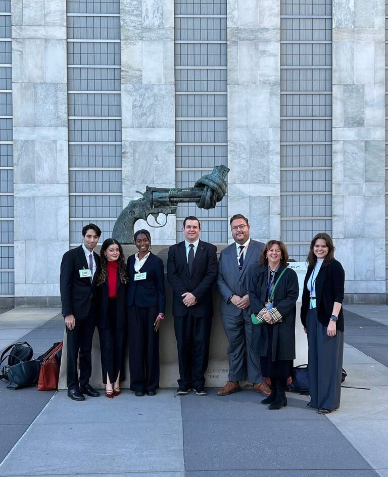 Tariq Rajei (2L), Mina Nur Basmaci (3L), Andrea Charles (3L), Zej Moczydlowski (3L), Douglas Pivnichny (WashU Law ’13, UN Legal Officer, Codification Division), Professor Leila Sadat, and Kelly Adams (WashU Law ’22, Legal Advisor, Global Justice Center) at the Non-Violence statue in the central United Nations plaza