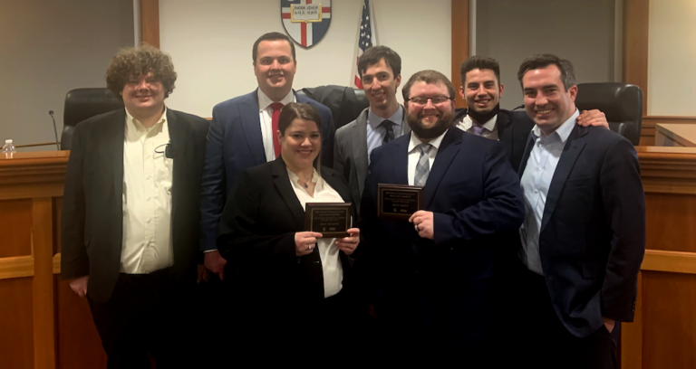 WashULaw's National Technology and Telecommunications Moot Court Competition participants Professor Richard Finneran, WashULaw alumnus Giles Howard, Bryce Beal, Adeline Miller, Rob Servilio, Adrian Spencer-Smith, Derek Lee, and Sean Mangan.