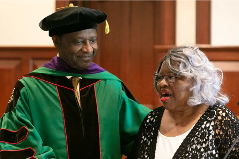 Edward Washington II, JD ’82 with a woman at a graduation ceremony