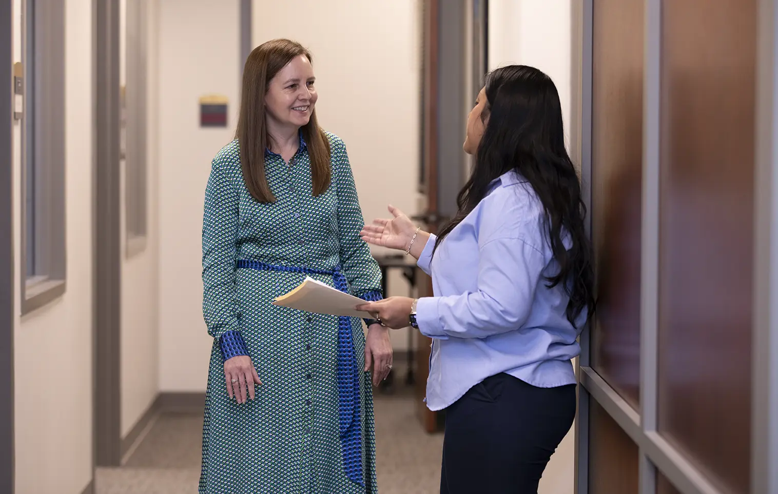 WashU Law faculty consulting in the halls.