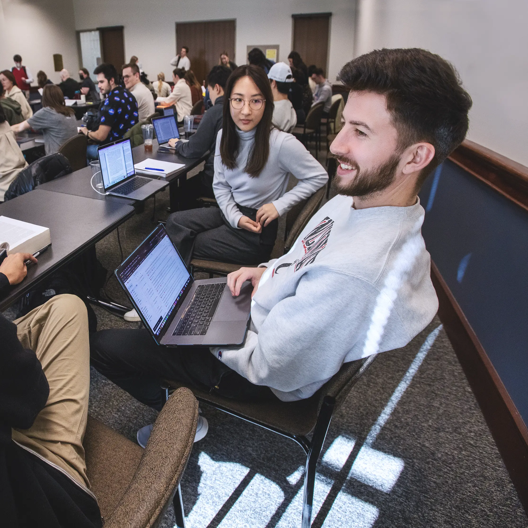 WashU Law students working on their laptops.