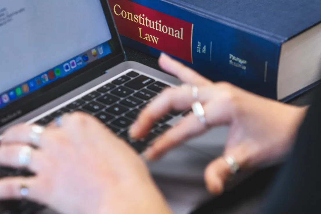 Student studying Constitutional Law while working on laptop.